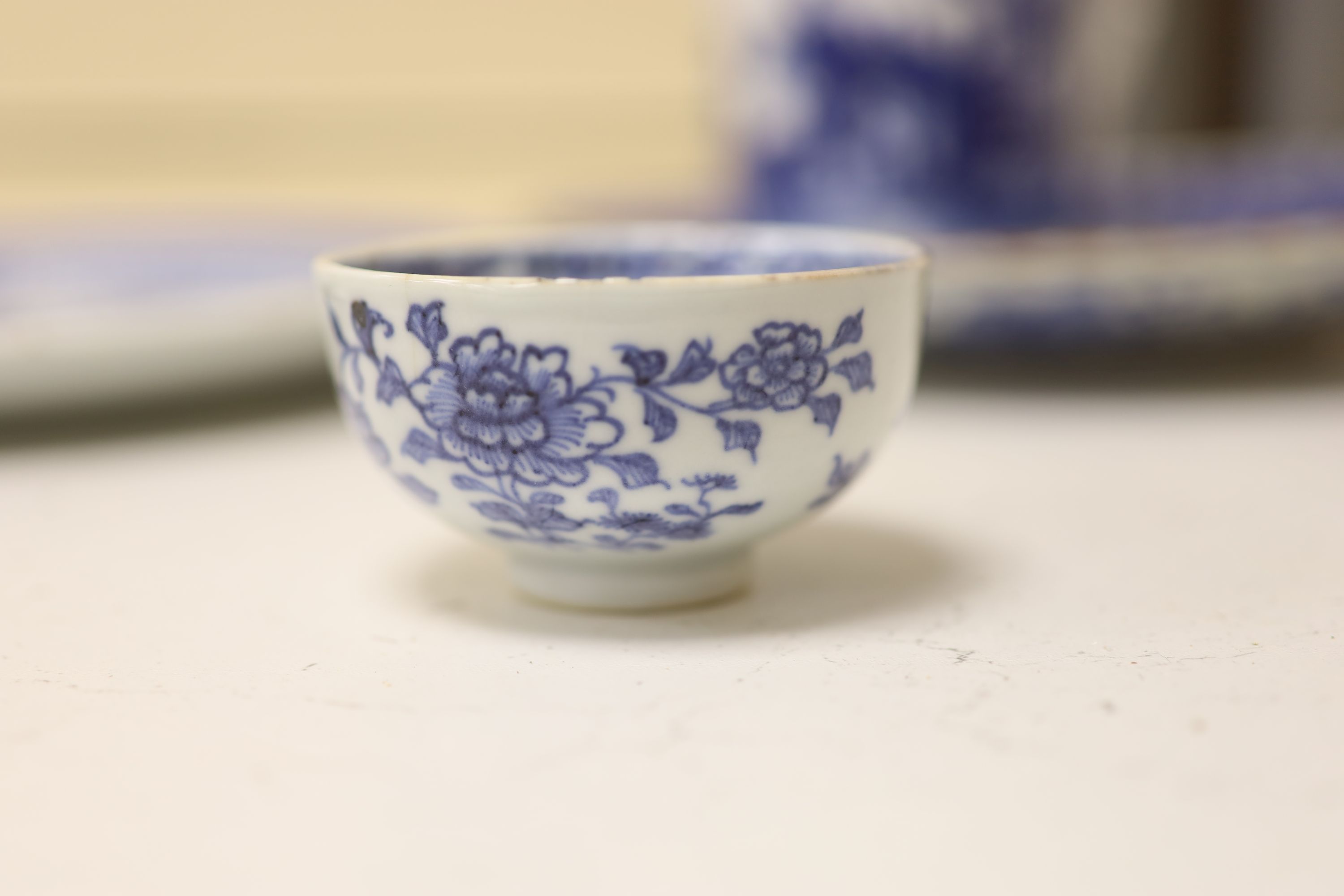 An 18th century Chinese blue and white mug and cup, a 19th century Chinese blue and white plate and a Japanese plate